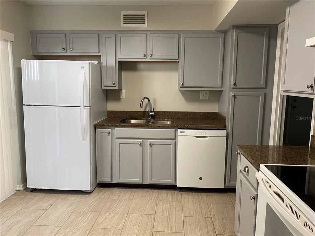 4400 Castlepalm Road Orlando, FL 32839 - Photo 6 of 38 a white refrigerator freezer sitting inside of a kitchen