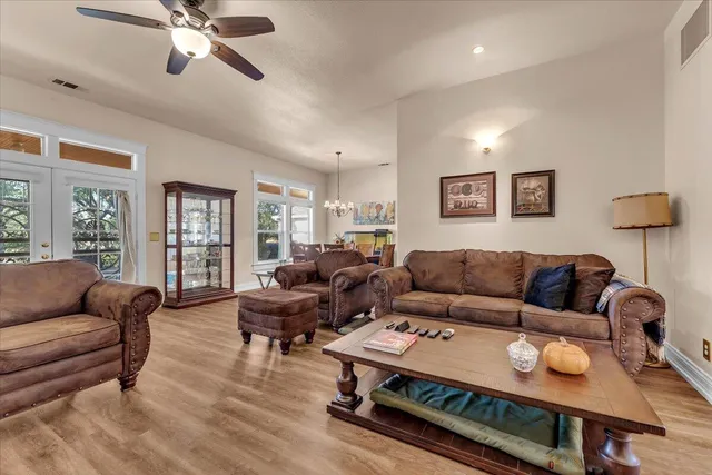 a living room with furniture and a chandelier