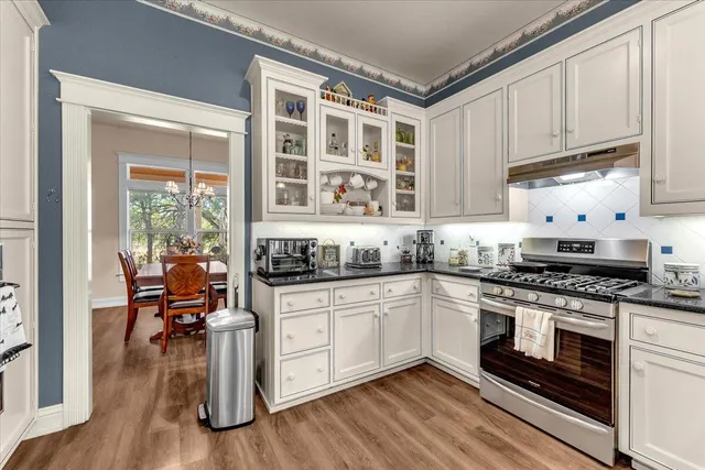 a bathroom with a tub a double vanity sink and mirror