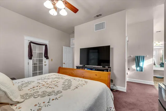 a bed room with a bed and a chandelier