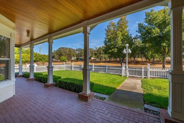 a view of a patio with table and chairs with wooden fence and plants