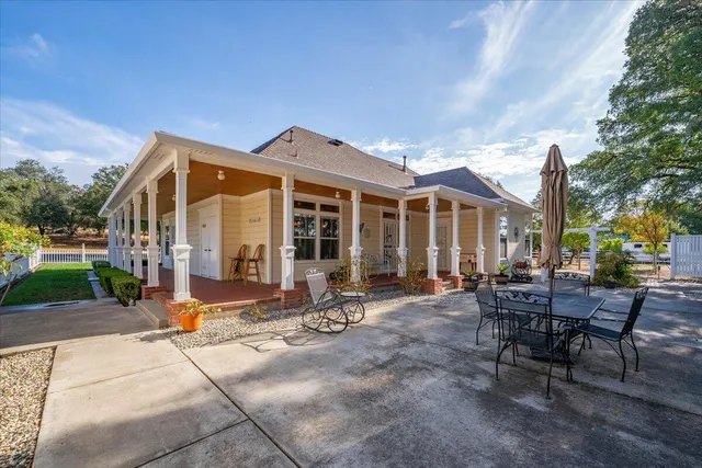 a view of a big house with a big yard and plants