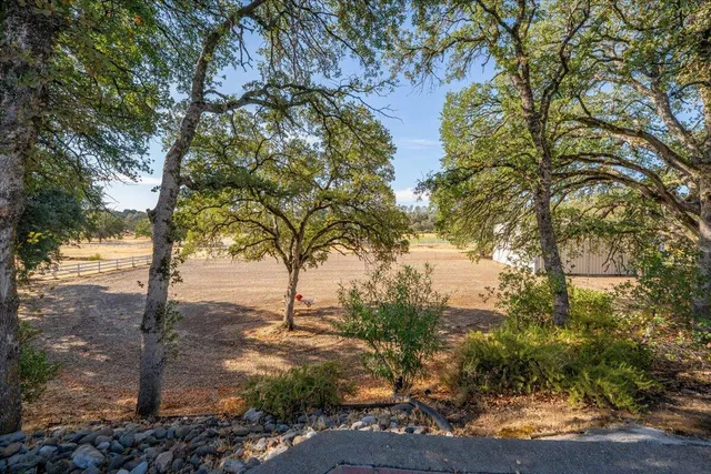 front view of a house with a yard and a garage
