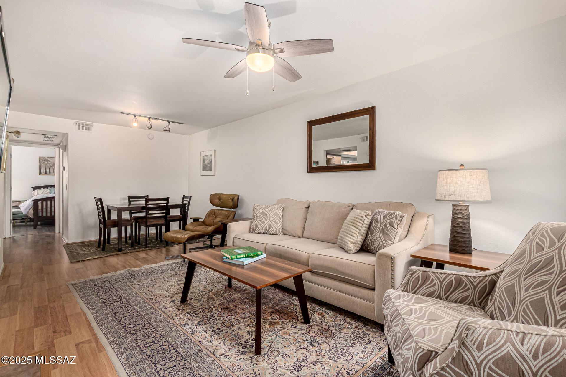 5855 North Kolb Road, Unit 8102 Tucson, AZ 85750 - Photo 3 of 28 a living room with furniture a rug and a chandelier