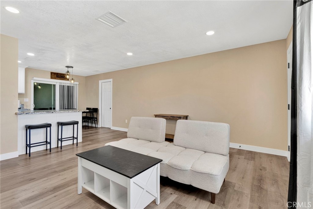 15471 Washoan Road Apple Valley, CA 92307 - Photo 8 of 38 a living room with furniture and a flat screen tv