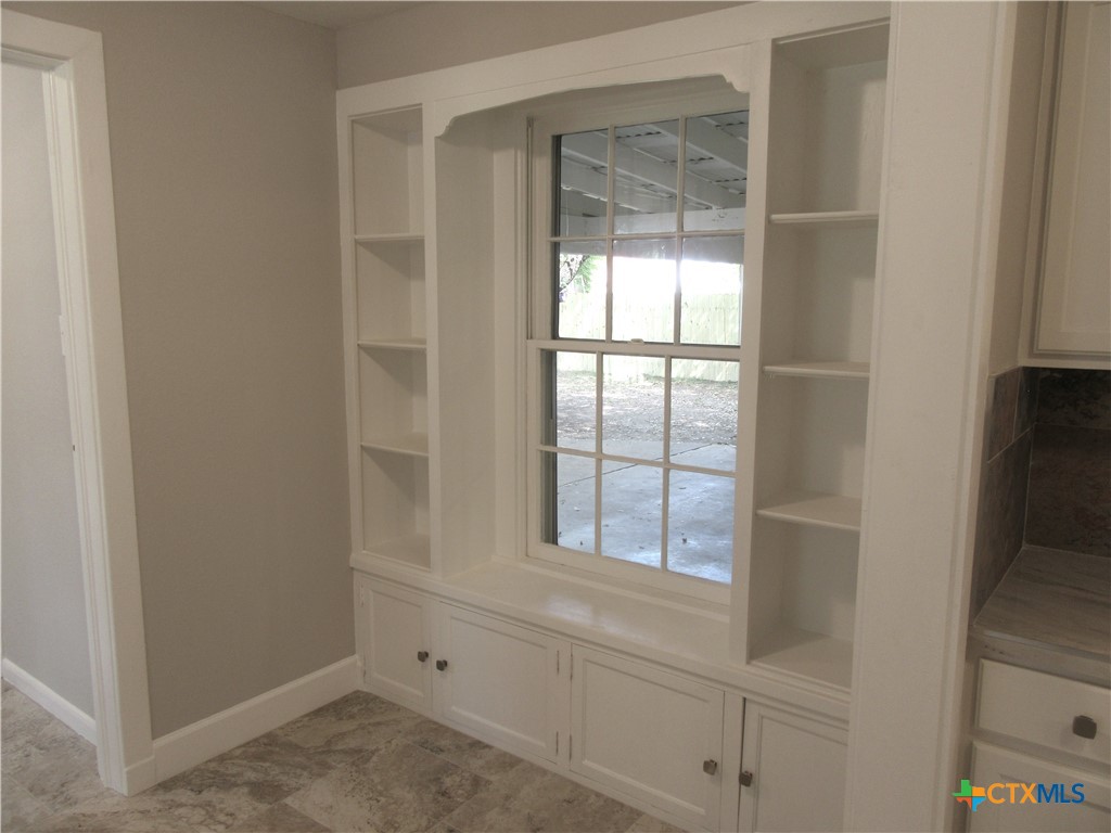 415 Easy Street Marlin, TX 76661 - Photo 17 of 45 a view of an empty room with wooden floor and cabinet
