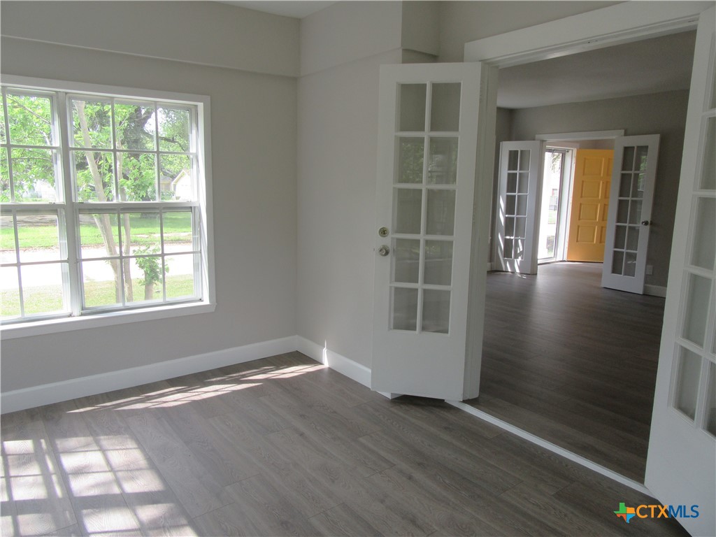 415 Easy Street Marlin, TX 76661 - Photo 19 of 45 an empty room with wooden floor and windows