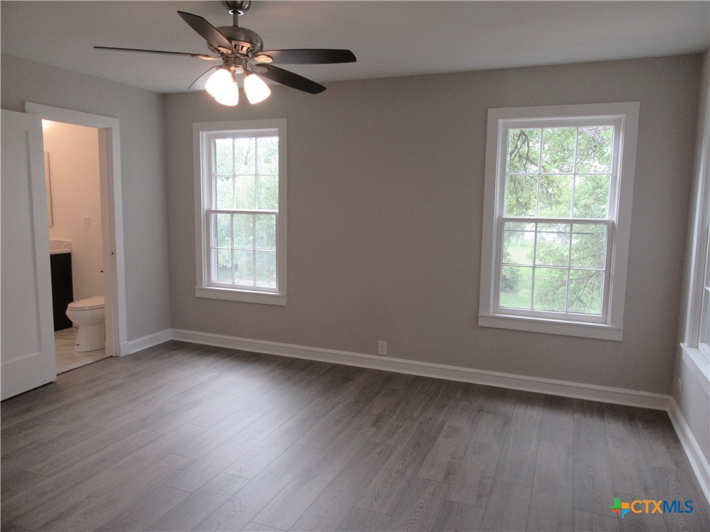 415 Easy Street Marlin, TX 76661 - Photo 22 of 45 a view of an empty room with wooden floor and a window
