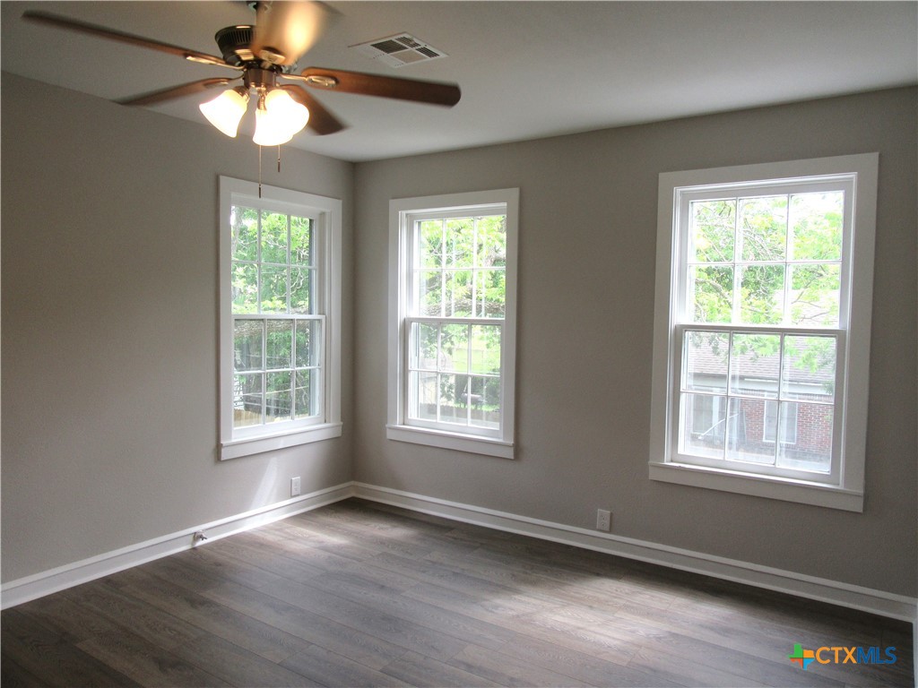 415 Easy Street Marlin, TX 76661 - Photo 29 of 45 a view of an empty room with wooden floor and a window