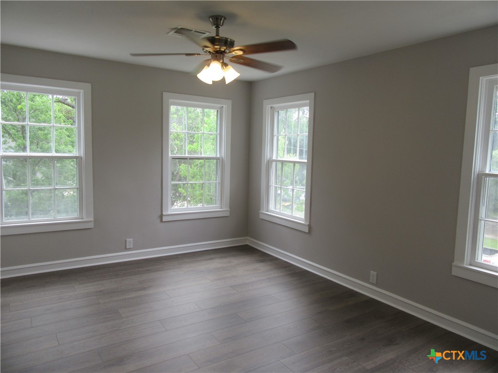 415 Easy Street Marlin, TX 76661 - Photo 31 of 45 a view of an empty room with wooden floor and a window