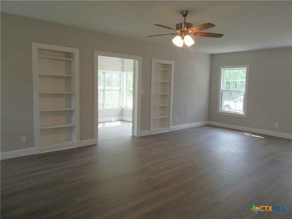 415 Easy Street Marlin, TX 76661 - Photo 7 of 45 a view of an empty room with a window and wooden floor