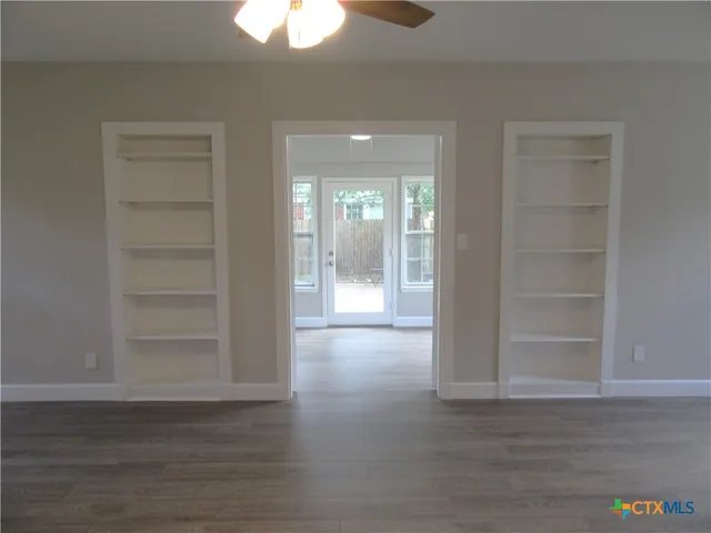 a view of wooden floor and windows in a room