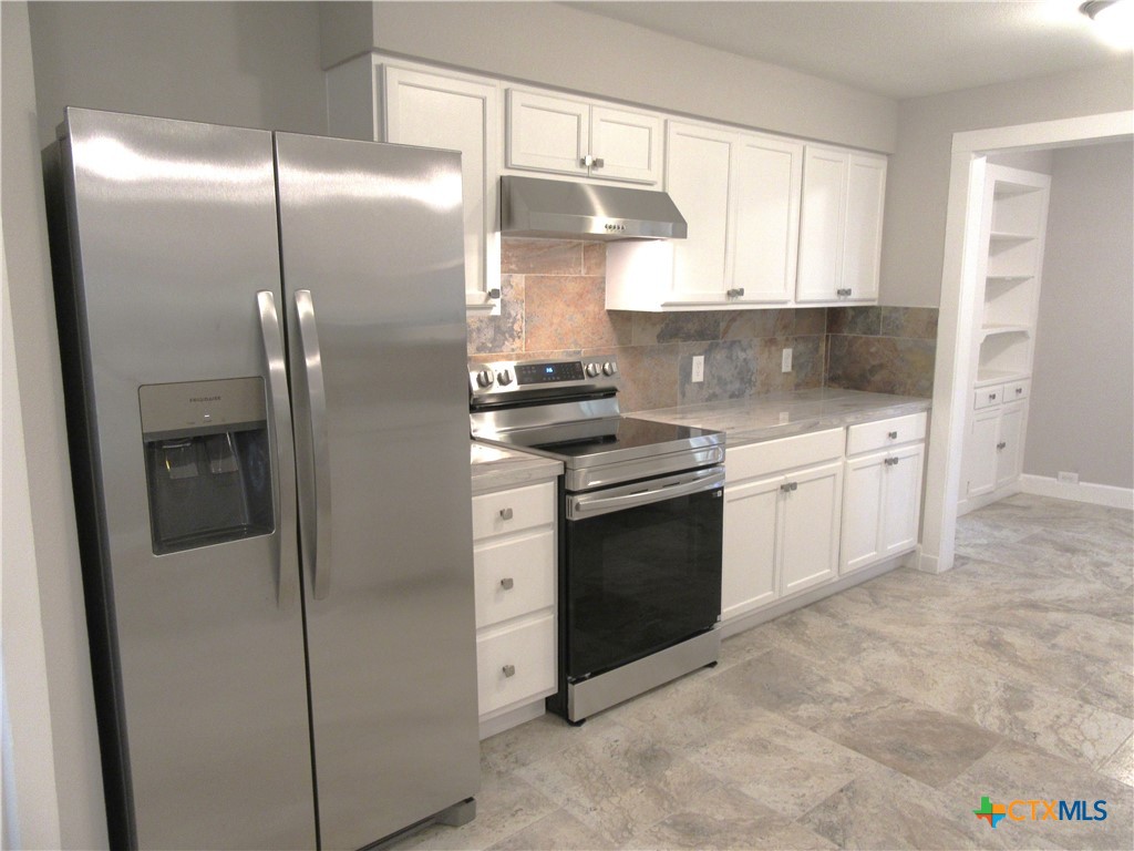 415 Easy Street Marlin, TX 76661 - Photo 9 of 45 a kitchen with a stove and a refrigerator