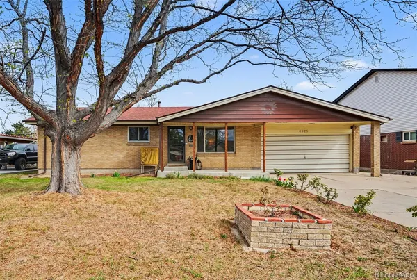 a backyard of a house with barbeque oven table and chairs