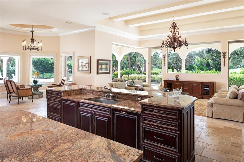 219 Cheshire Way Naples, FL 34110 - Photo 16 of 46 a kitchen with stainless steel appliances granite countertop a stove and a sink