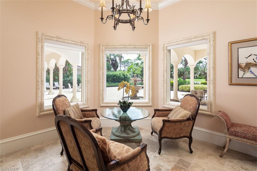 219 Cheshire Way Naples, FL 34110 - Photo 18 of 46 a dining room with furniture wooden floor and a chandelier