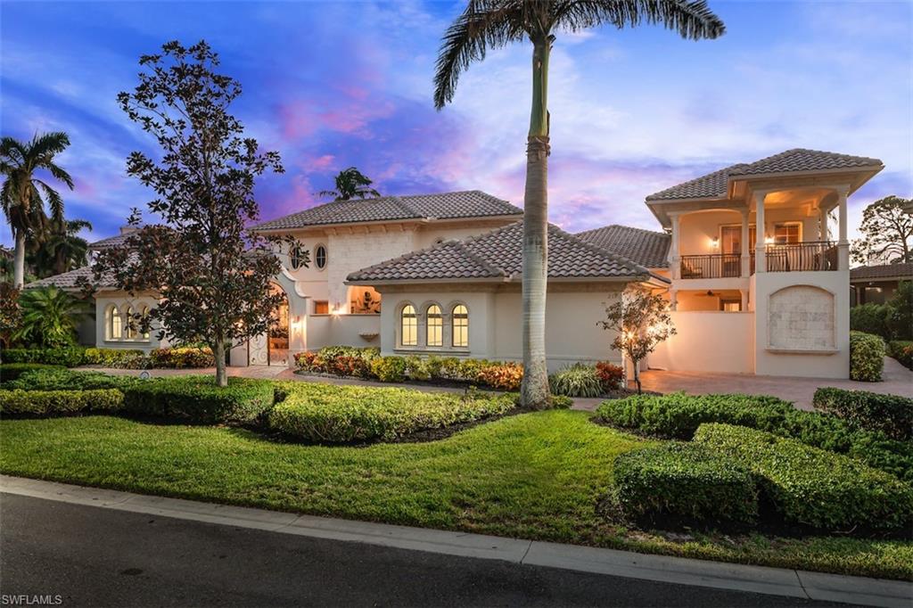 219 Cheshire Way Naples, FL 34110 - Photo 2 of 46 a front view of a house with a yard