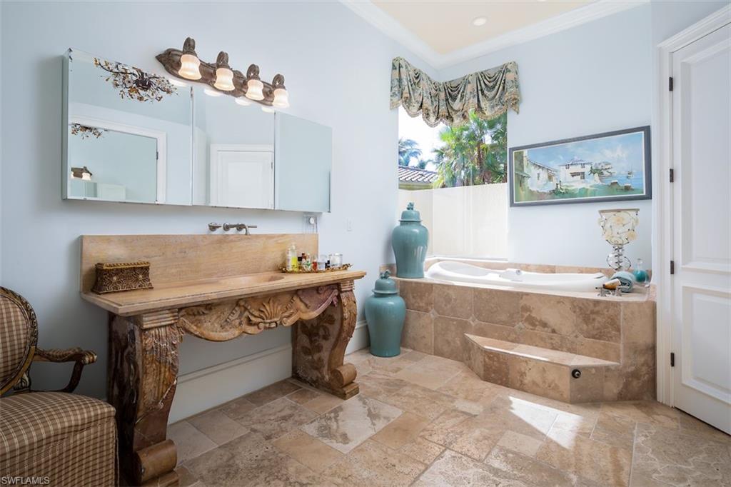 219 Cheshire Way Naples, FL 34110 - Photo 23 of 46 a view of cabinets a washer and dryer