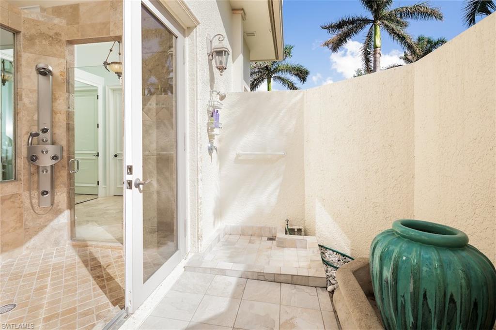 219 Cheshire Way Naples, FL 34110 - Photo 24 of 46 a view of a walk in closet and bathroom
