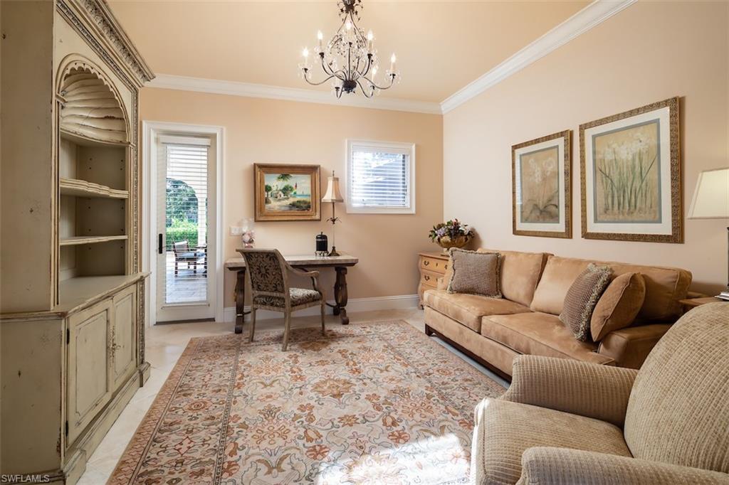 219 Cheshire Way Naples, FL 34110 - Photo 27 of 46 a living room with furniture a dining table and a window with wooden floor