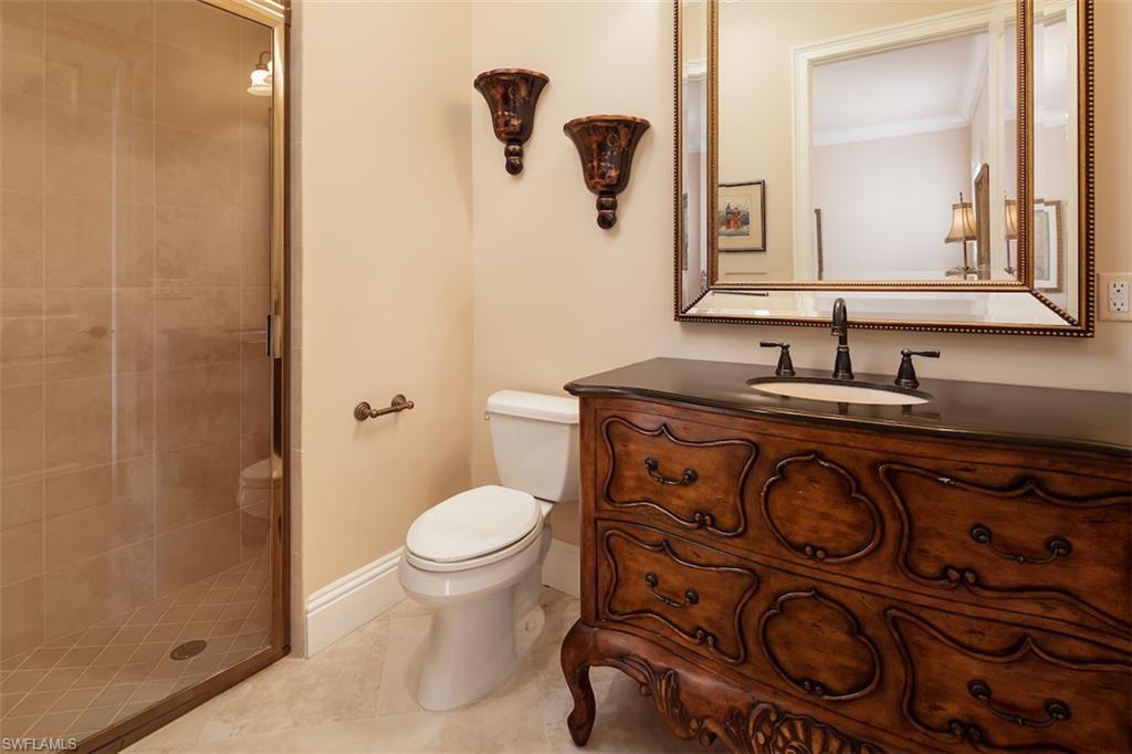 219 Cheshire Way Naples, FL 34110 - Photo 28 of 46 a bathroom with a toilet sink and mirror
