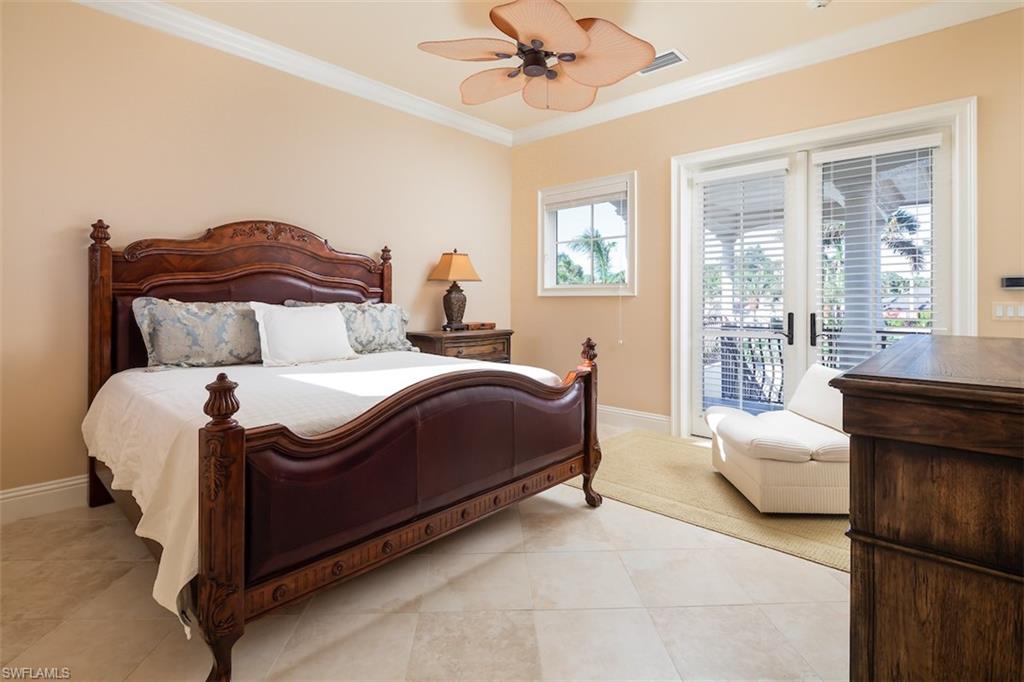 219 Cheshire Way Naples, FL 34110 - Photo 29 of 46 a spacious bedroom with a bed and glass window