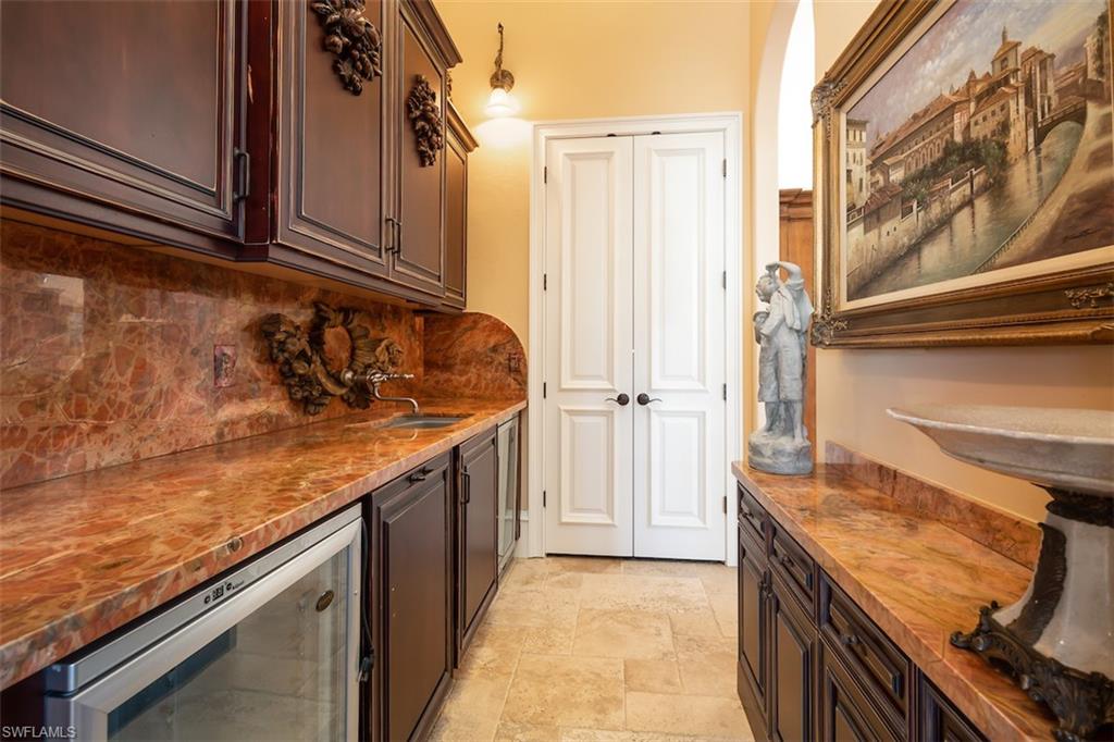 219 Cheshire Way Naples, FL 34110 - Photo 31 of 46 a kitchen with a sink and cabinets