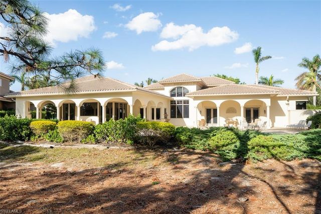 a view of a white house with a yard