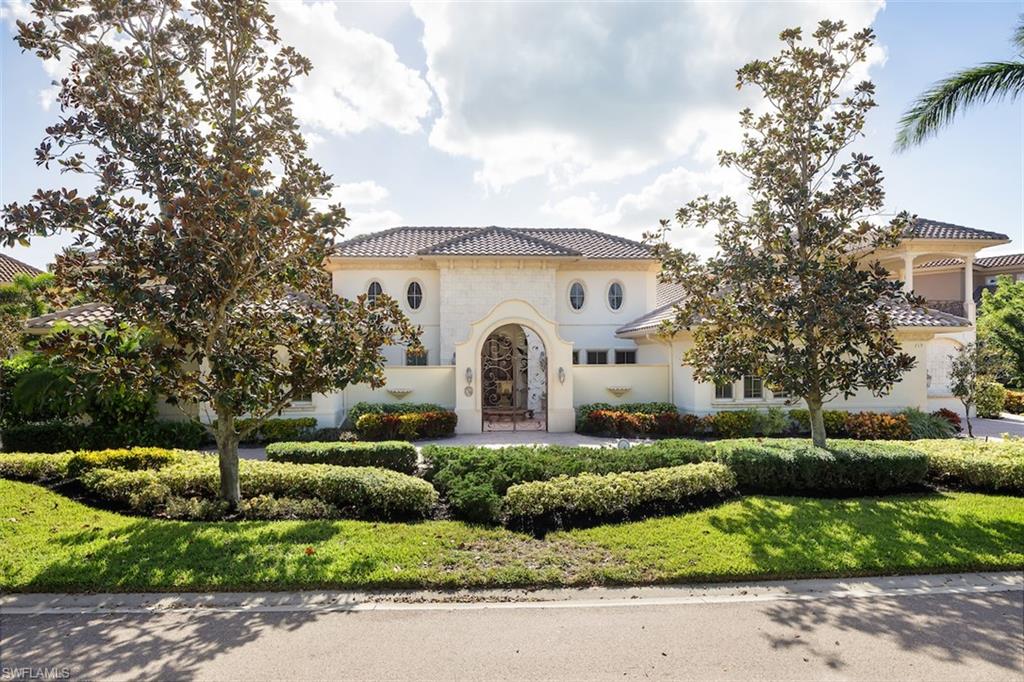 219 Cheshire Way Naples, FL 34110 - Photo 5 of 46 a front view of a house with a yard