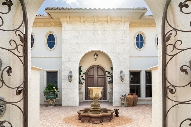 a living room with furniture and a mirror
