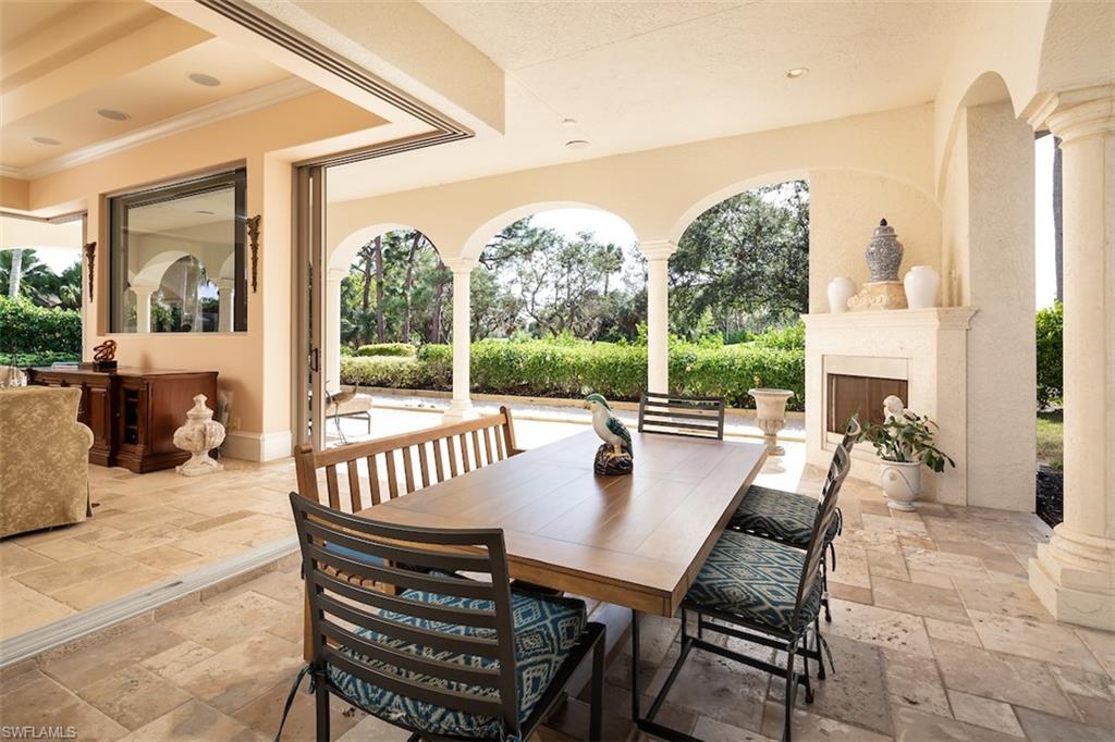 219 Cheshire Way Naples, FL 34110 - Photo 9 of 46 a view of a patio with a table chairs and a balcony
