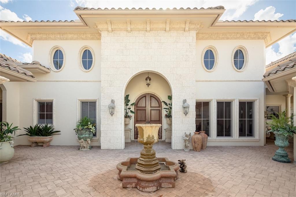 219 Cheshire Way Naples, FL 34110 - Photo 10 of 46 a front view of a house with garden
