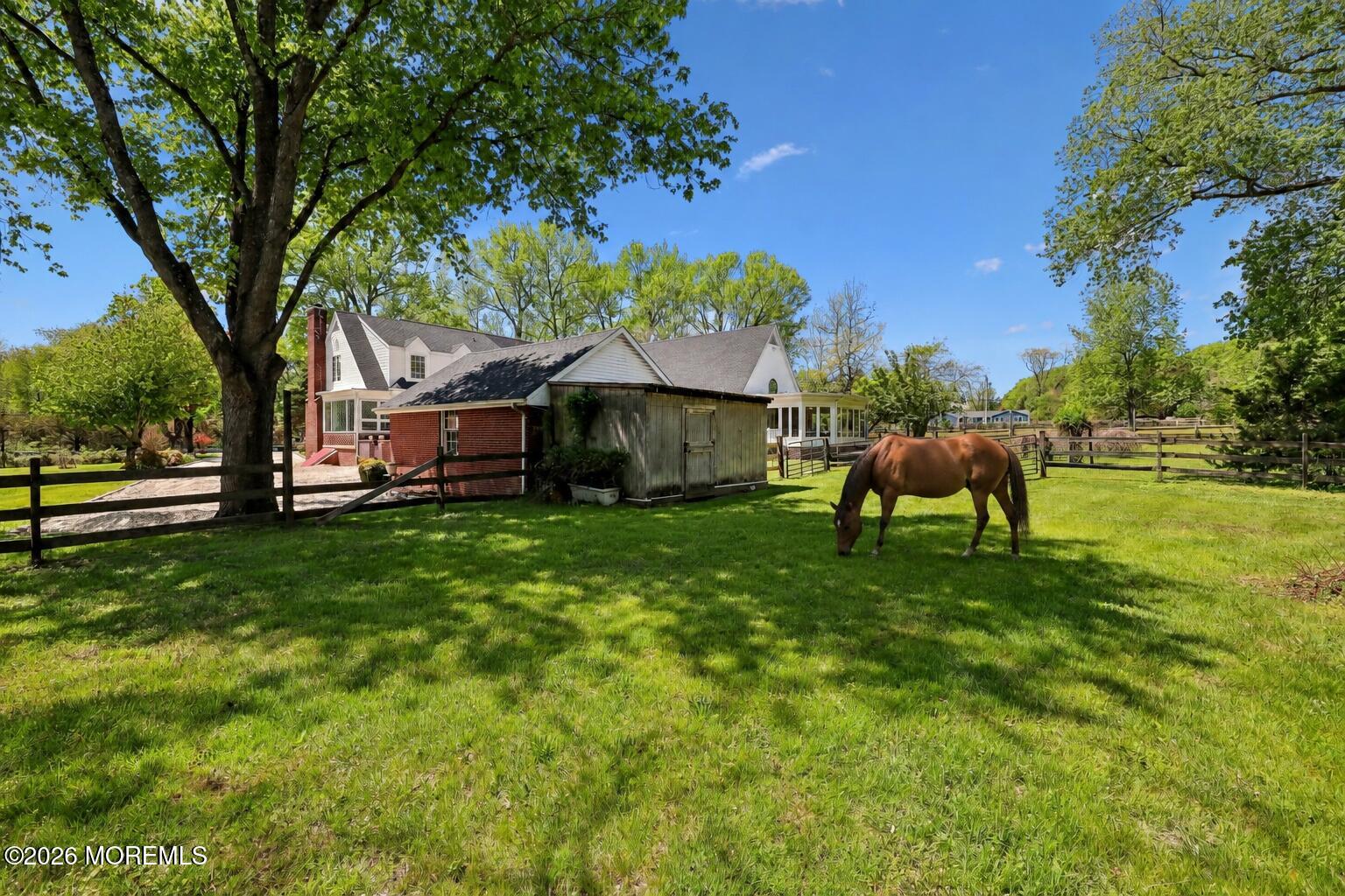 187 Hockhockson Road Colts Neck, NJ 07722 - Photo 46 of 55 a backyard of a house with table and chairs