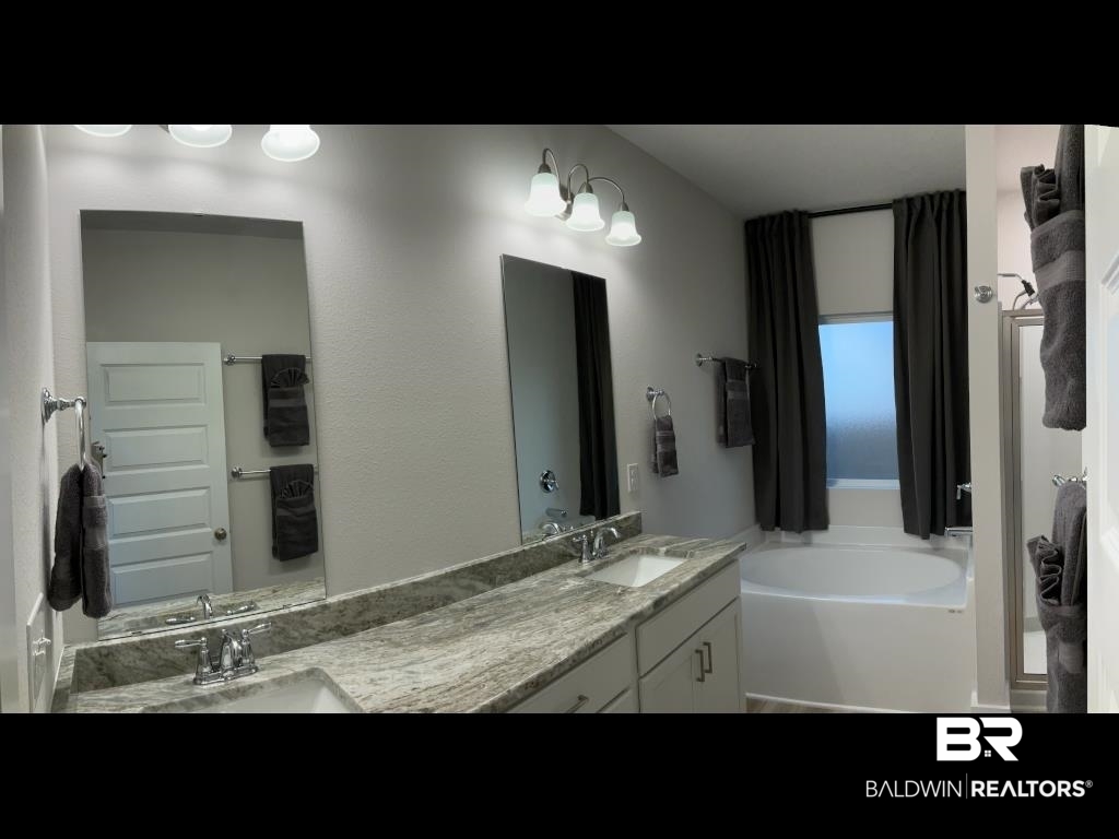 1093 Pheasant Circle Foley, AL 36535 - Photo 11 of 25 Bathroom with double vanity and a bath