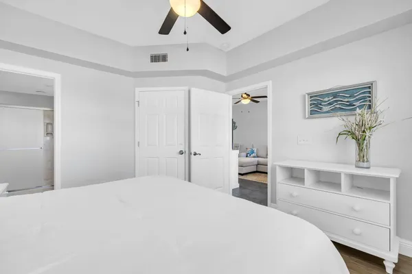a bedroom with a large bed and a desk
