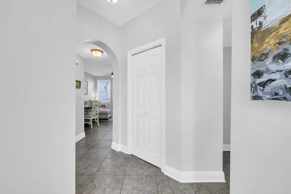 a view of a hallway with a livingroom and a workspace