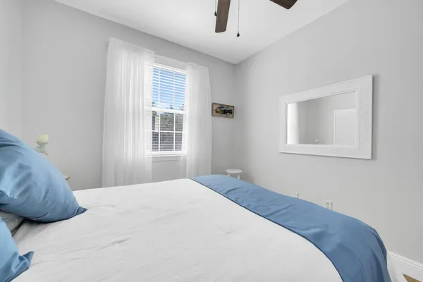a bedroom with a bed and a window