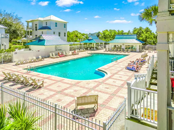 a view of an swimming pool with a porch and furniture