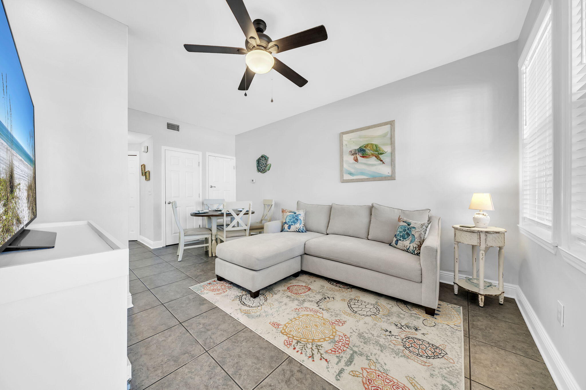 86 Village Boulevard, Unit 411 Santa Rosa Beach, FL 32459 - Photo 3 of 42 a living room with furniture and a flat screen tv