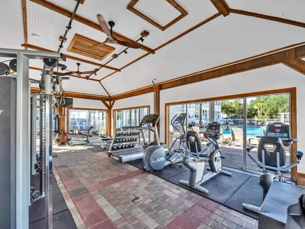 a view of a room with gym equipment and large windows