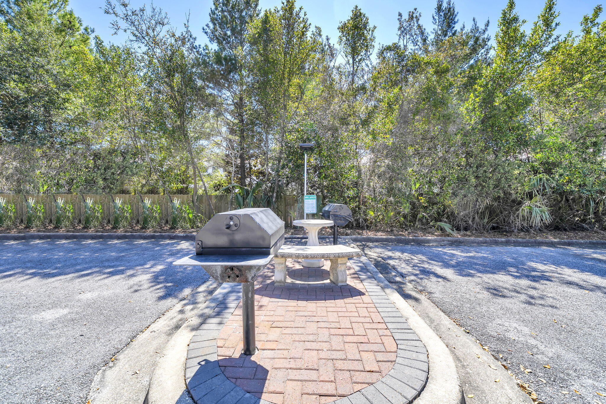 86 Village Boulevard, Unit 411 Santa Rosa Beach, FL 32459 - Photo 37 of 42 a view of a backyard with table and chairs