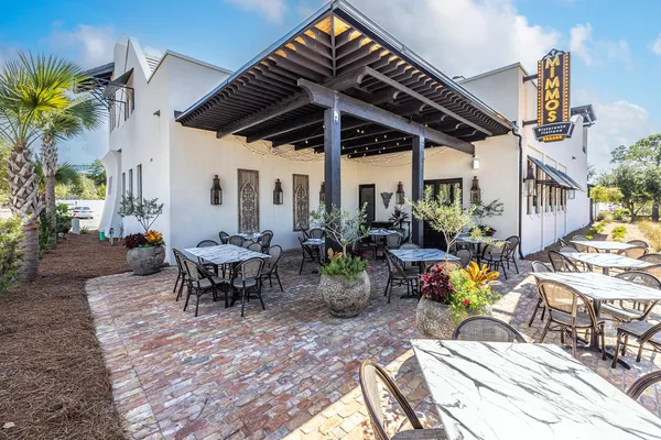 a view of a patio with table and chairs potted plants