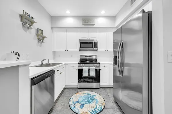 a kitchen with a refrigerator and a sink