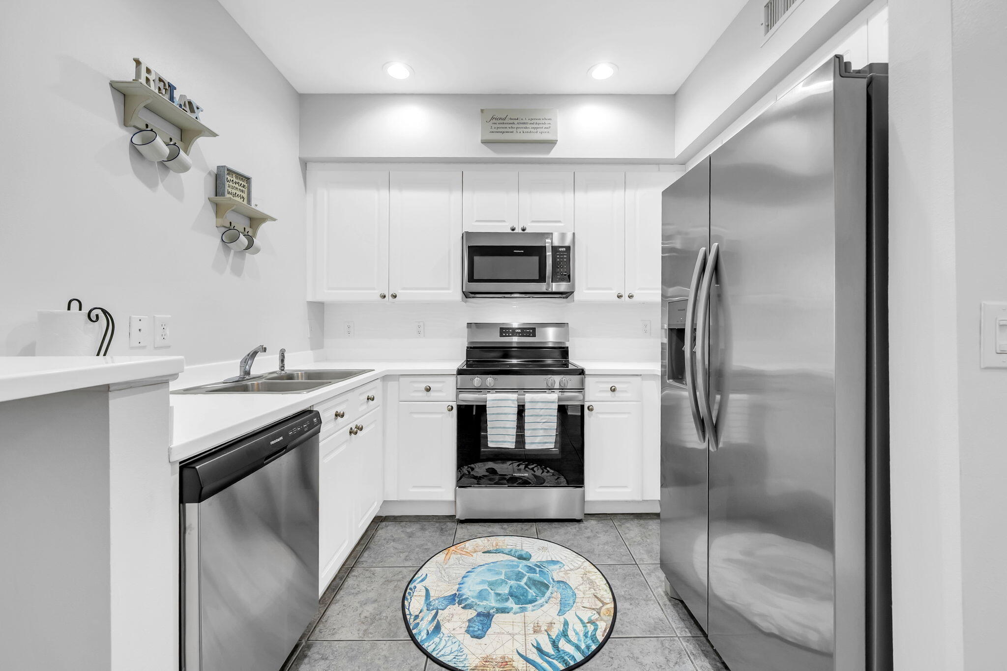 86 Village Boulevard, Unit 411 Santa Rosa Beach, FL 32459 - Photo 6 of 42 a kitchen with a refrigerator and a sink