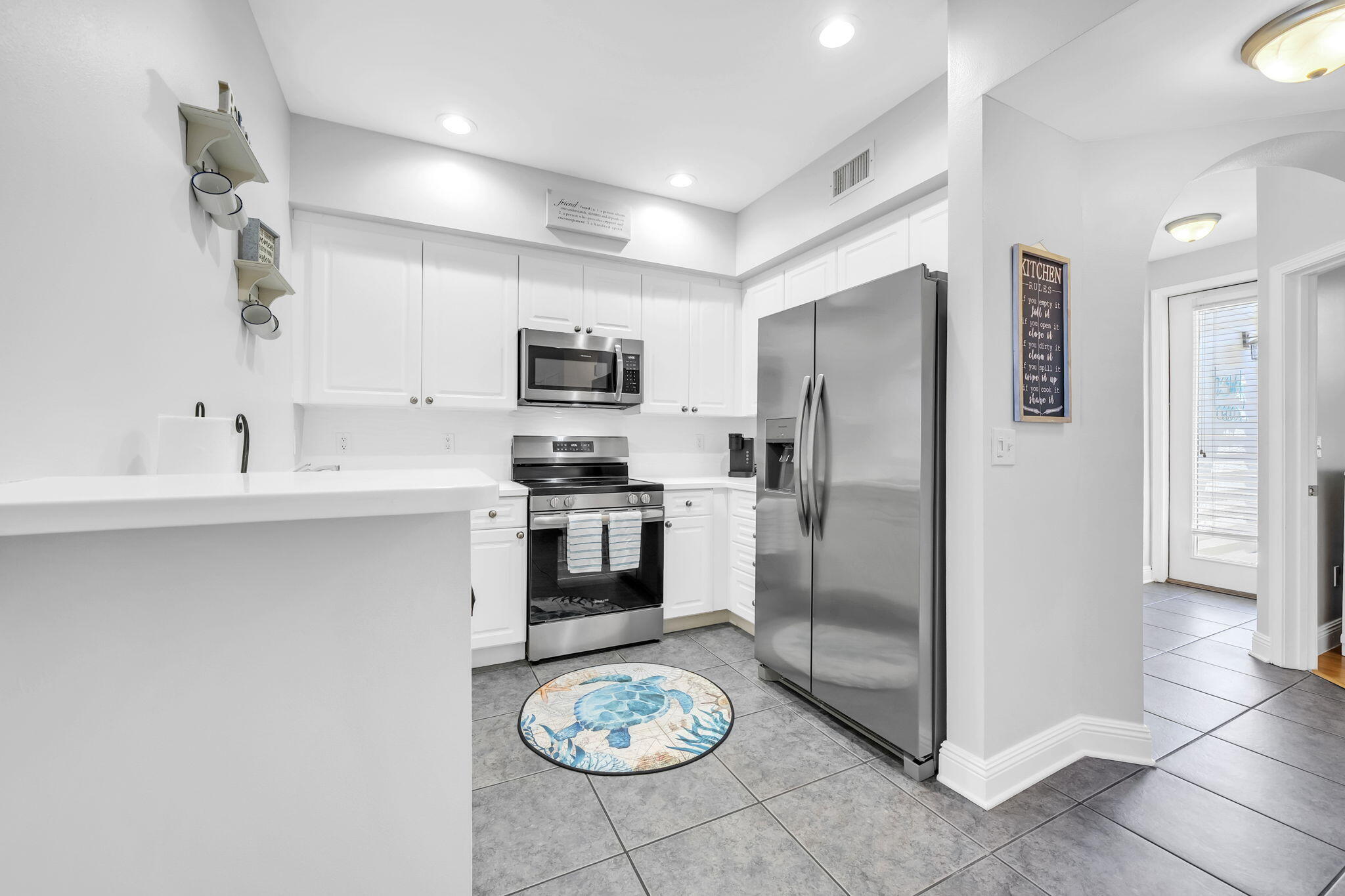 86 Village Boulevard, Unit 411 Santa Rosa Beach, FL 32459 - Photo 7 of 42 a kitchen with stainless steel appliances a refrigerator sink and stove