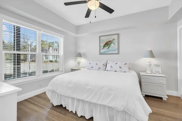a bedroom with a large bed and a chandelier