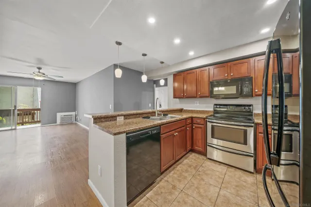 a kitchen with stainless steel appliances granite countertop a stove and a sink
