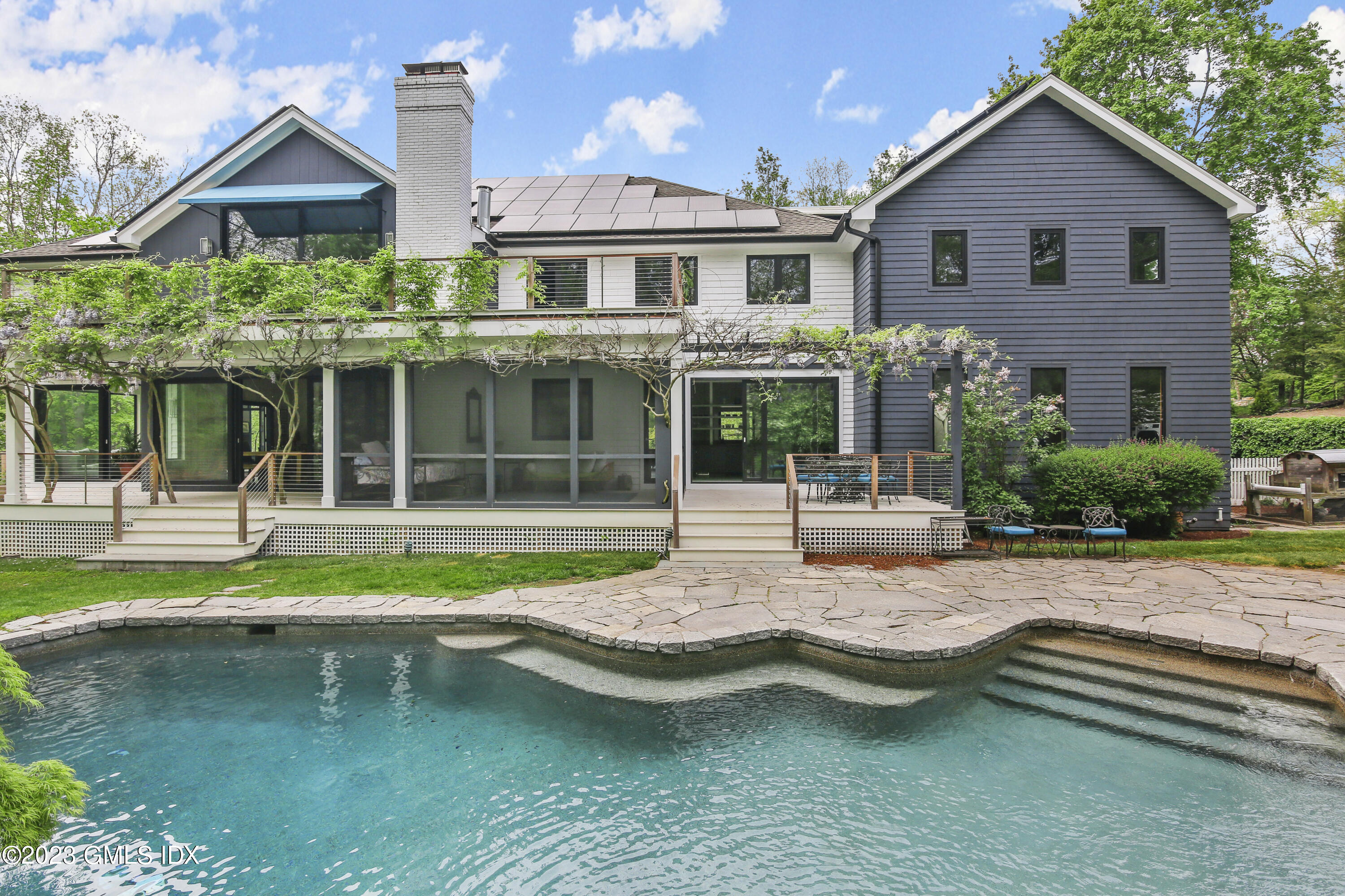 a front view of a house with a yard table and chairs