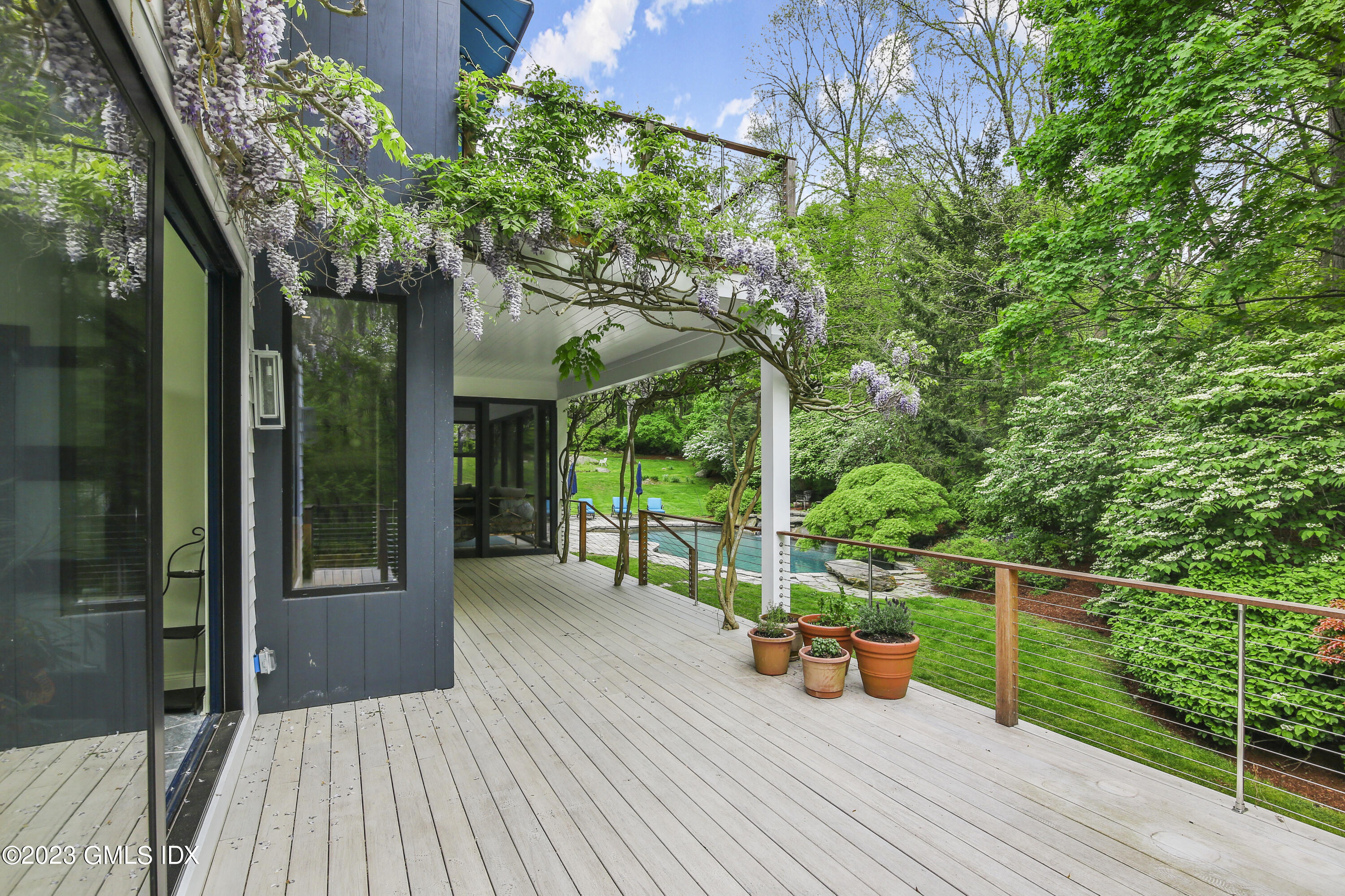 56 Dingletown Road Greenwich, CT 06830 - Photo 15 of 38 a view of a chair and tables in the balcony
