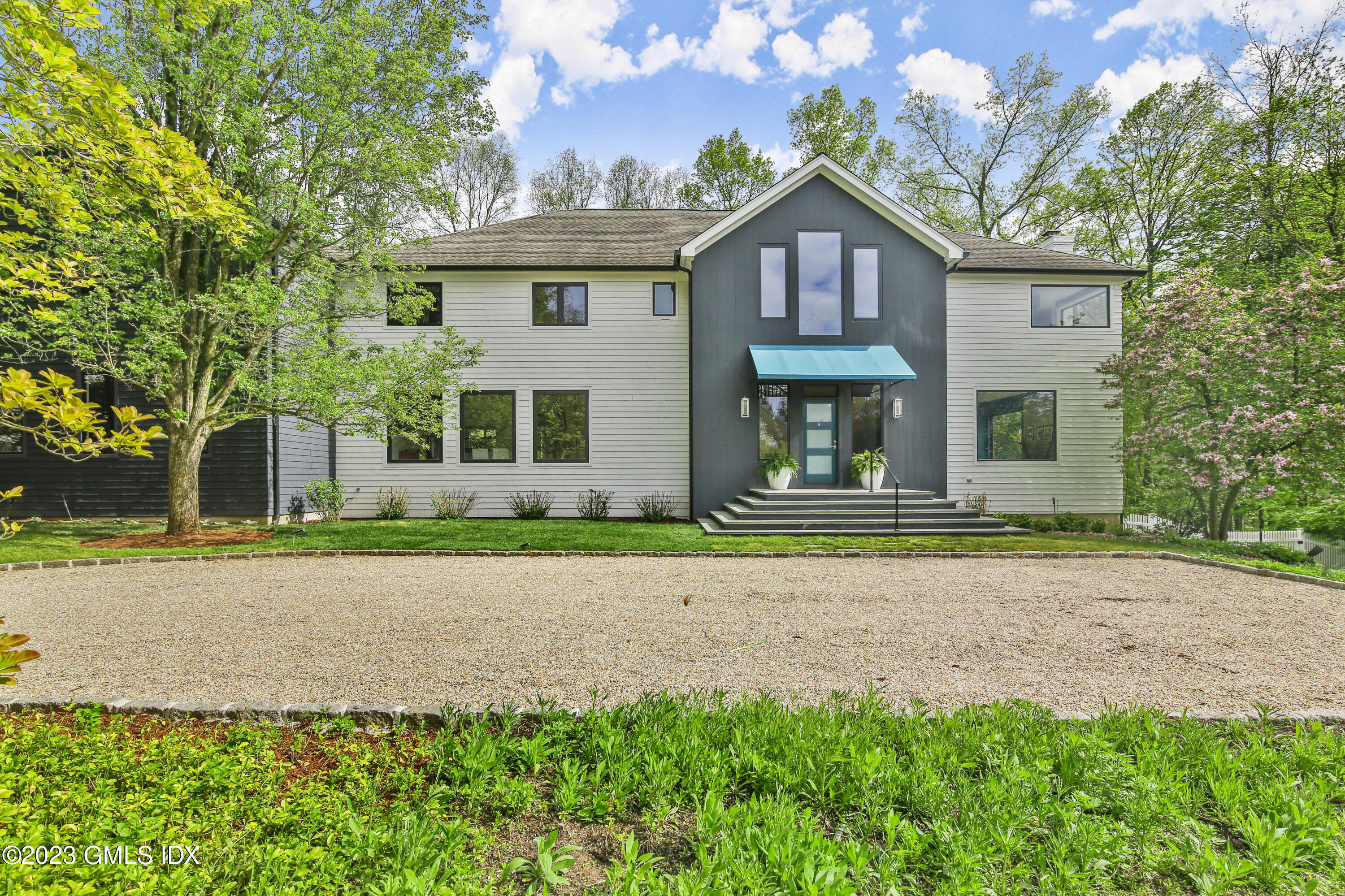 56 Dingletown Road Greenwich, CT 06830 - Photo 2 of 38 a front view of a house with a yard and a garage